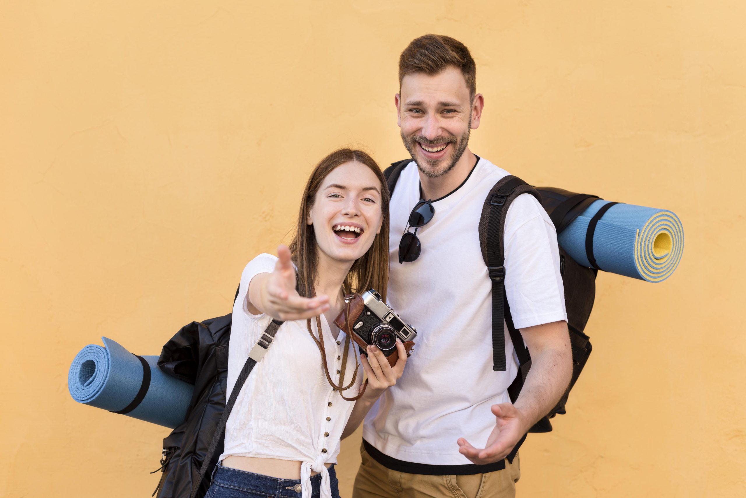 smiley tourist couple with backpacks camera scaled