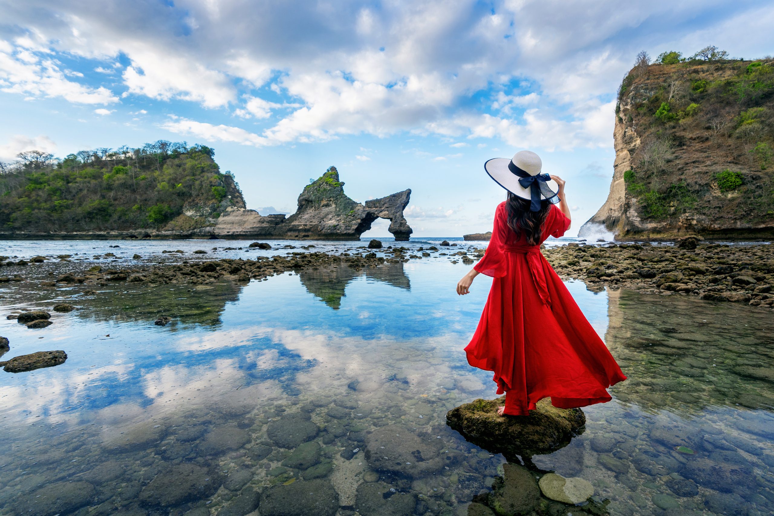 woman standing rock atuh beach nusa penida island bali indonesia scaled